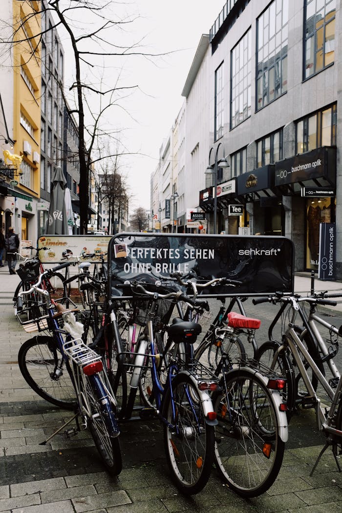 A row of parked bicycles on a busy European city street.